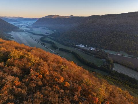 Aerial view of a valley with autumn colors on the hillsides and a light mist in the distance, Ple&Aring;&iexcl;ivec, Ko&Aring;&iexcl;ice Region, Slovakia.