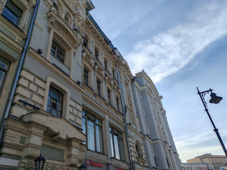 historical pink building with multiple floors, adorned with decorative features and air conditioning units on its windows. The combination of classic design and modern amenities highlights urban