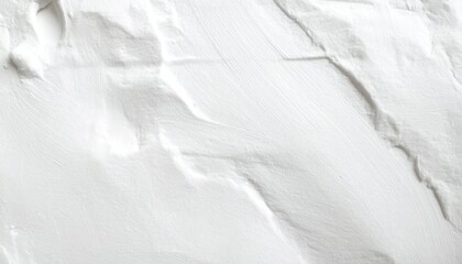 Fototapeta premium Close-up of textured white surface—thick paint or plaster with intersecting strokes and ridges—minimalist and abstract, capturing tool movement and tactile depth in a quiet visual rhythm.
