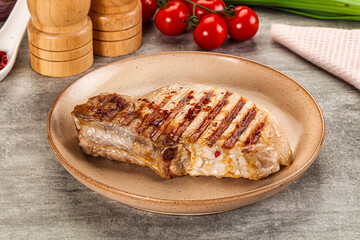 Grilled pork loin steak with bone