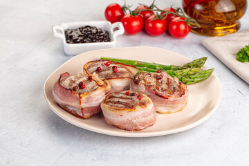 Tasty grilled pork medallion with bacon