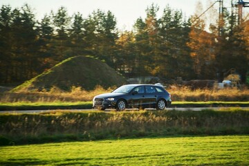 Fototapeta premium Stylish estate vehicle on sunny countryside trip