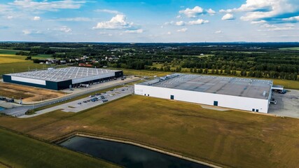 Modern factory buildings near agriculture land