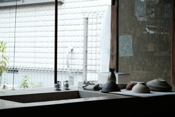 indoor view with ceramic tableware by the sink