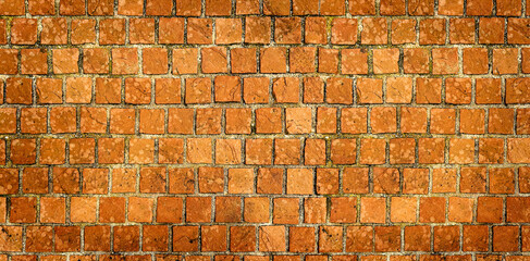 Panoramic, dark brick wall in red tones in a ruined house. Concept textures and backgrounds