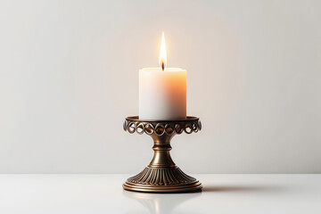 Elegant antique brass candlestick holding a lit white candle