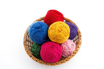 Colorful balls of yarn in a woven basket on a white background