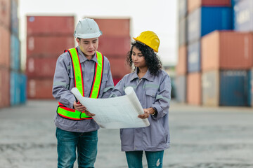 Industrial container workers discuss sustainable logistics operations. Analyzing blueprint, including zero emissions, reducing fuel consumption and carbon footprint in supply chain management