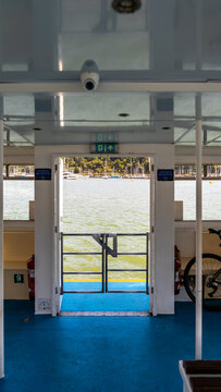 Open stern gate of ferry boat showing harbor with moored boats