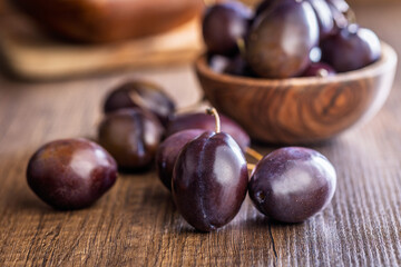 Ripe plums on wooden table.