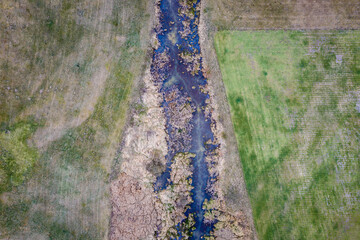Drone photo of water canal on a pasturage during drought in Mazowsze region of Poland