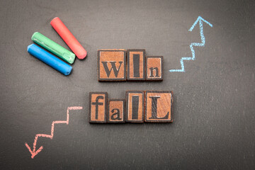Concept image illustrating success and failure with chalk-drawn arrows pointing upward and downward...