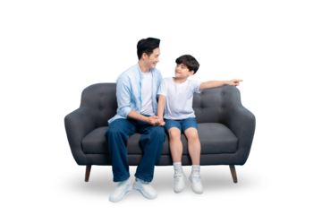 A father and son sharing a moment on the sofa, with the boy pointing with his hand on PNG background.