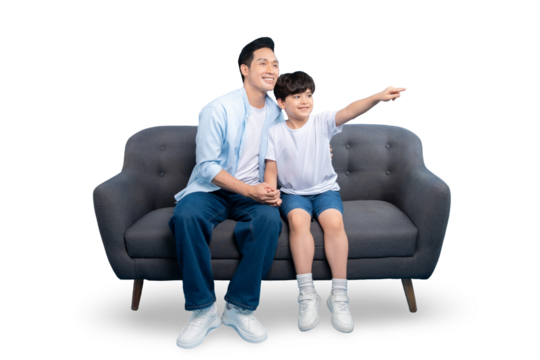 A father and son spending quality time while sitting together on the sofa and pointing in front on PNG background