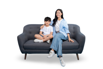 A mother and son are sitting together on a gray sofa, with a happy and harmonious feeling. The background is plain