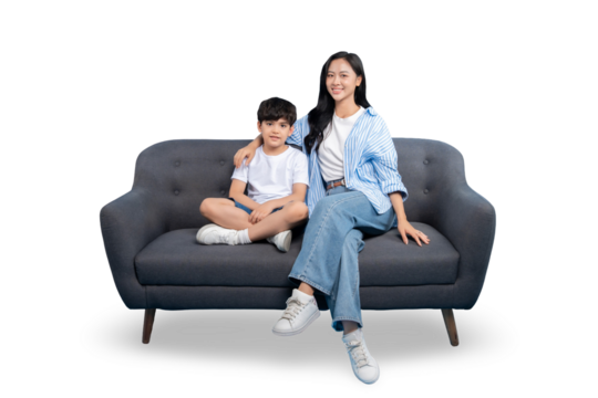 A mother and son are sitting together on a gray sofa, with a happy and harmonious feeling. The background is plain