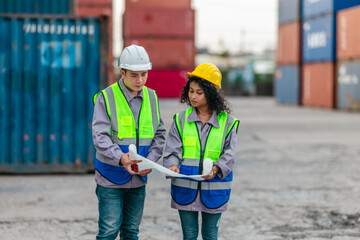 Industrial container workers discuss sustainable logistics operations. Analyzing blueprint, including zero emissions, reducing fuel consumption and carbon footprint in supply chain management