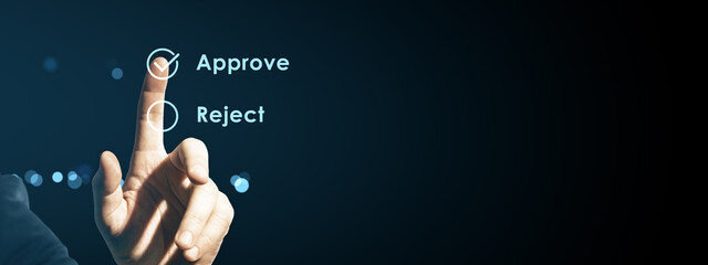 Human finger pressing approve button on digital touchscreen interface with glowing neon UI elements...