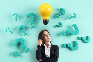 Businesswoman thinking with question marks and yellow lightbulb symbolizing creative idea and...
