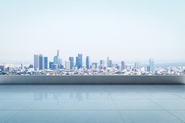 Empty rooftop with clean tiled floor and panoramic view of modern city skyline under clear sky in...