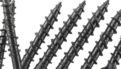 A close-up macro shot of a shiny metal screw and screwdriver isolated on a white background