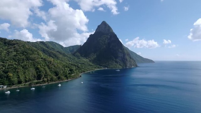 Aerial view of the majestic Pitons mountains meeting the deep blue sea, contrasting with the lush green hills, creating a scenic view, Le Pitons, Soufri&egrave;re, Saint Lucia.