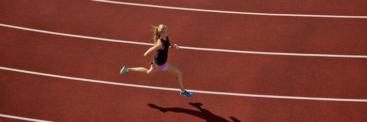 Young athlete sprinting on red track with dynamic shadow below. Concept of sprint stride, athletic motion, racing energy, competitive progress, and focused performance. Banner
