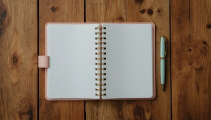 An open spiral-bound notebook with lined pages sits atop a wooden surface, alongside a mint-green pen, showcasing a clean, organized, and neutral aesthetic.