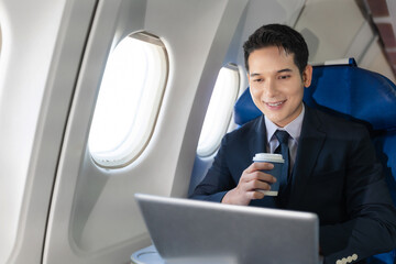 Traveling and technology. young business man working on Laptop and smartphone while sitting in...