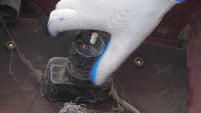 unscrewing an old automatic electrical plug, hand unscrews a fuse plug in an old electrical panel, retro plug with a circuit breaker