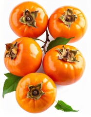 Fototapeta premium Group of Ripe Orange Persimmon Fruits with Green Leaves on a White Background