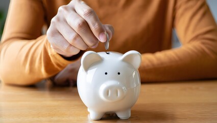 Man putting coin in piggy bank. Saving money concept, business finance and investment.