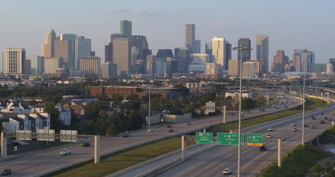 Establishing drone shot of downtown Houston and 288 freeway during sunset 