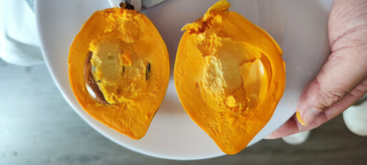 Juicy orange sapote halves glisten, evoking Dia de Muertos flavors, ripe tropical indulgence,...