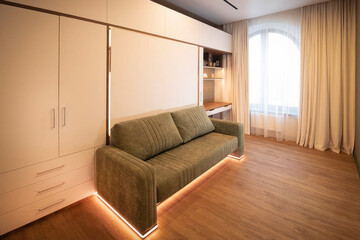 Cozy minimalist studio with glowing sofa, ambience of Nordic hygge, International Stay-at-Home Day, modern tranquility nook