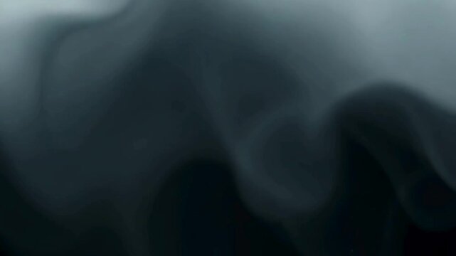 A mesmerizing video of abstract, ghostly gray smoke or fluid flowing slowly against a dark background