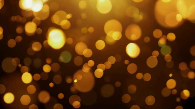 A visually stunning video of abstract, shimmering golden bokeh lights slowly floating and moving on a dark background