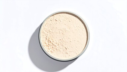 Light beige powder in a round container