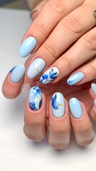 Light blue nails with floral designs