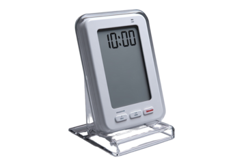 White rectangular digital device with a clear acrylic stand. Shows a digital clock display and several buttons