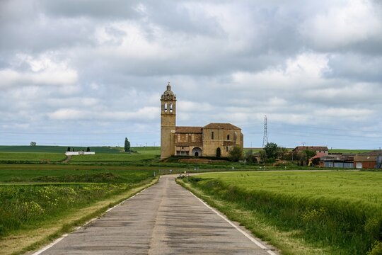 Santa Maria Arbis Church in Baquerin de Campos with road leading to entrance