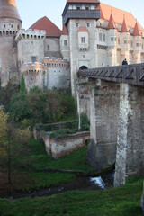 Main entrance of Corvin Castle, Romania. Wooden bridge crosses the moat to majestic Gothic towers...