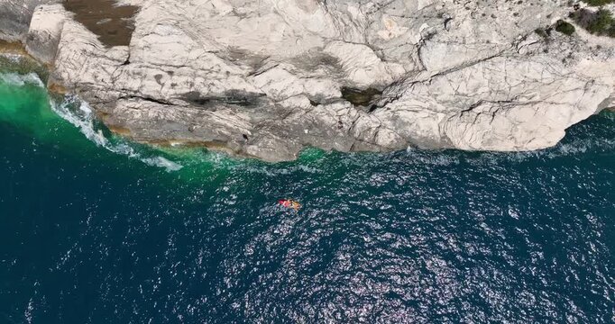 Above View Of Kayaker Along The Rock Shores Of Dugi Otok Island In Croatia. Aerial Topdown Shot