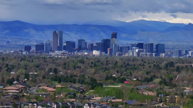 Downtown Denver skyscraper front range foothills landscape view aerial drone Colorado Northfield Stapleton Central Park spring morning rain clouds sunny cityscape Capitol building forward zoom in