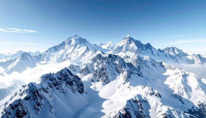 Obraz premium Majestic Mountainscape: A breathtaking aerial view of towering, snow-capped peaks under a clear, blue sky, portraying the awe-inspiring grandeur of nature's artistry.