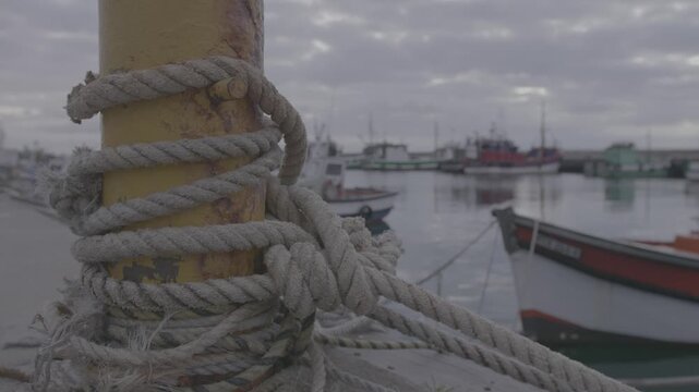 Rope holding a moored boat on Kalk Bay Harbour in Cape Town, South Africa.