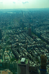 Fototapeta premium High angle view of central Taipei showing a dense concentration of residential buildings, towers, and urban structures under a pale sky