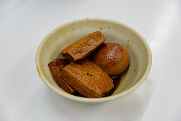 Braised tofu and egg in soy sauce, served in a small ceramic bowl, a classic Taiwanese side dish with rich savory flavor and dark glaze