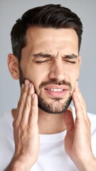 Obraz premium Man in pain, holding his jaw