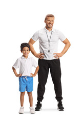 Full length portrait of a kid in blue shorts and white t-shirt posing with a sports coach